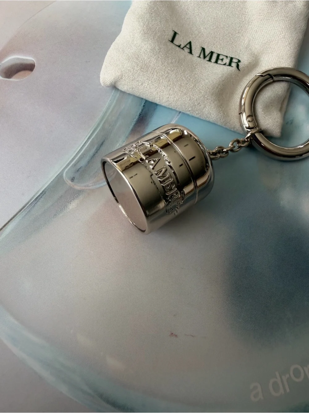 La Mer Silver Tone bag charm / Keychain with Drawstring Pouch